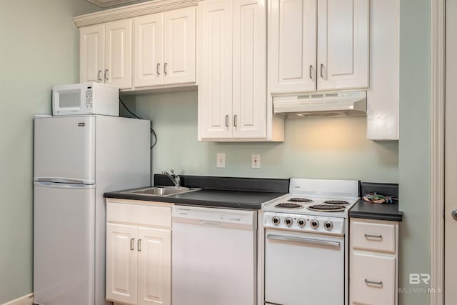 kitchen with white appliances, sink, and white cabinetry