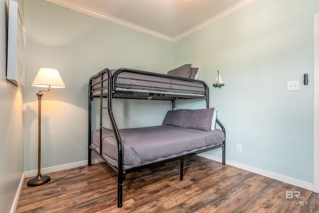 bedroom with hardwood / wood-style floors and crown molding