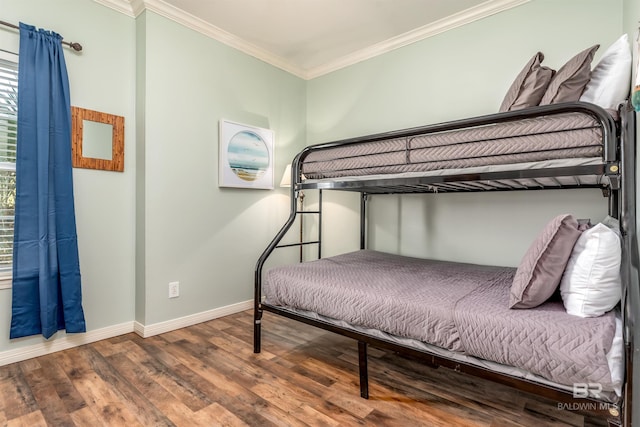 bedroom with ornamental molding and dark wood-type flooring