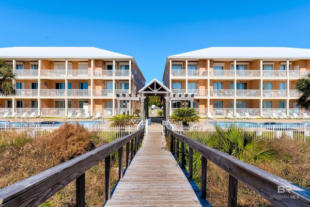 exterior space featuring a community pool and a balcony