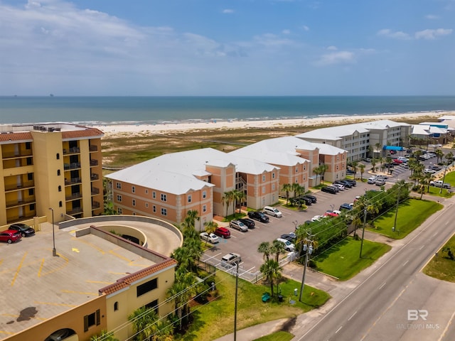 exterior space featuring a beach view and a water view