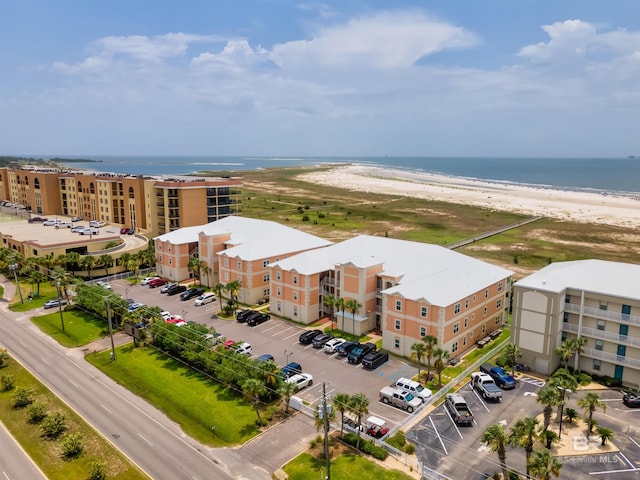 drone / aerial view featuring a beach view and a water view