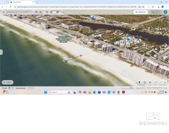 bird's eye view featuring a water view and a view of the beach