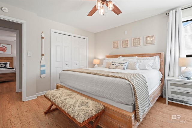 bedroom with light wood-style flooring, a closet, baseboards, and a ceiling fan