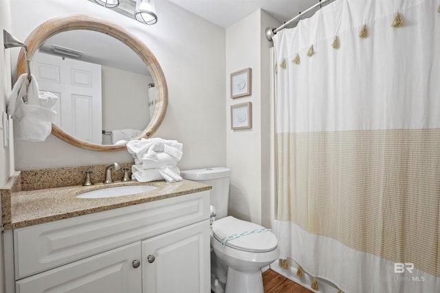 full bath featuring vanity, a shower with curtain, visible vents, toilet, and wood finished floors
