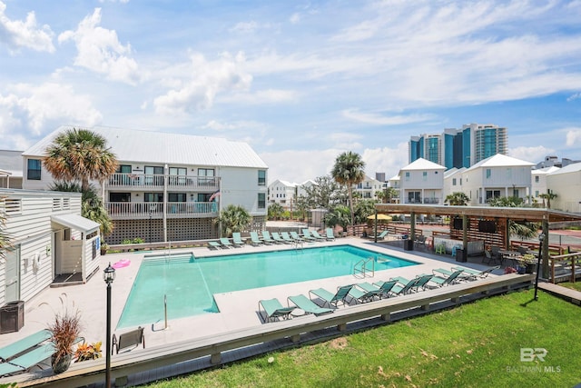 community pool with a patio and a residential view