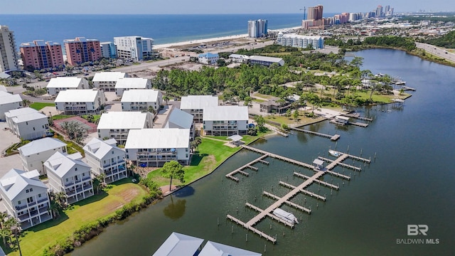 birds eye view of property with a water view and a view of city