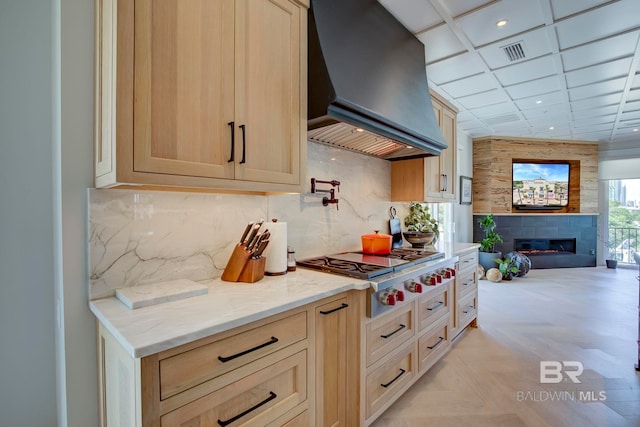 27269 Perdido Beach Blvd Unit C5A, Orange Beach, AL 36561 - kitchen with custom range hood, stainless steel gas cooktop, open floor plan, recessed lighting, and light stone counters