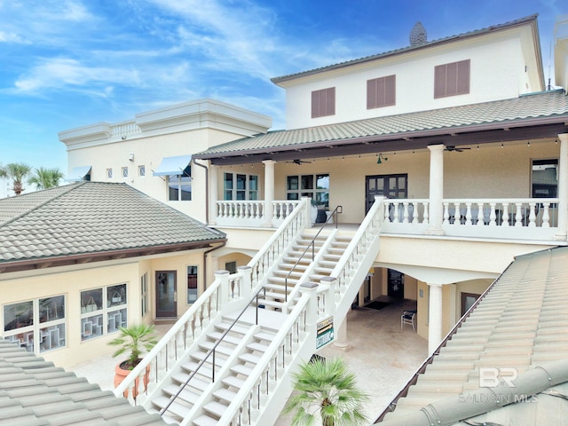 27269 Perdido Beach Blvd Unit C5A, Orange Beach, AL 36561 - rear view of house with stairway, ceiling fan, stucco siding, metal roof, and a tile roof