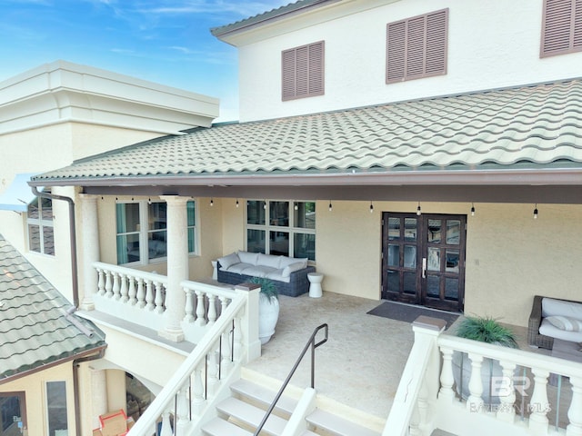 27269 Perdido Beach Blvd Unit C5A, Orange Beach, AL 36561 - doorway to property featuring french doors, a tile roof, and stucco siding
