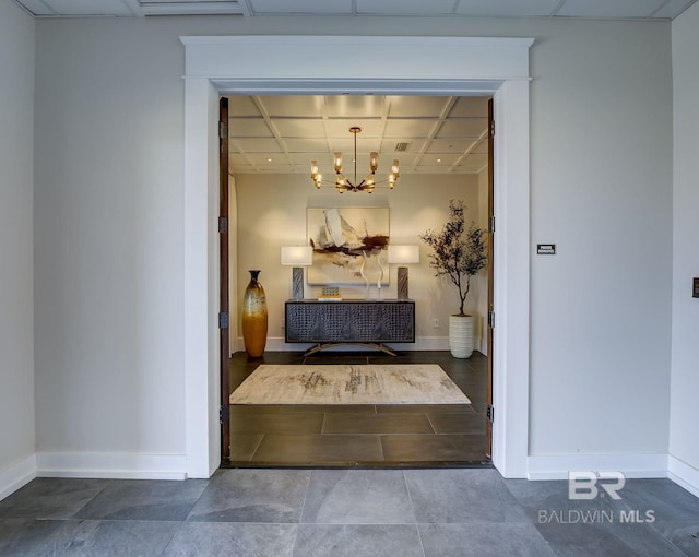 27269 Perdido Beach Blvd Unit C5A, Orange Beach, AL 36561 - hall with a drop ceiling, a chandelier, baseboards, and tile patterned floors