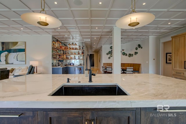27269 Perdido Beach Blvd Unit C5A, Orange Beach, AL 36561 - kitchen featuring open floor plan, a sink, light stone countertops, recessed lighting, and hanging light fixtures