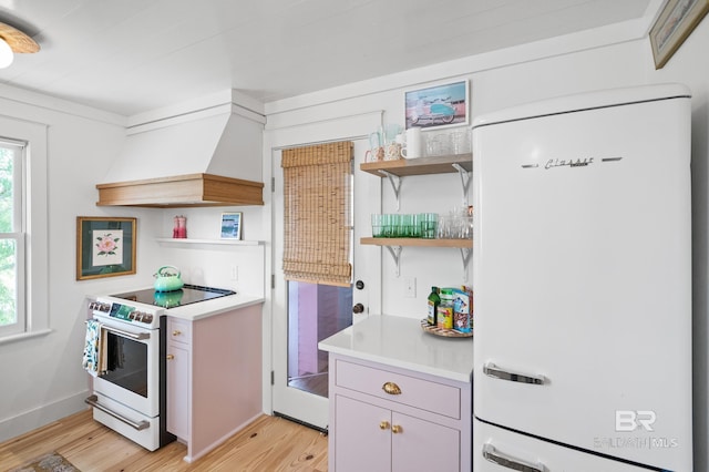 kitchen with custom range hood, white appliances, light countertops, open shelves, and light wood-style floors