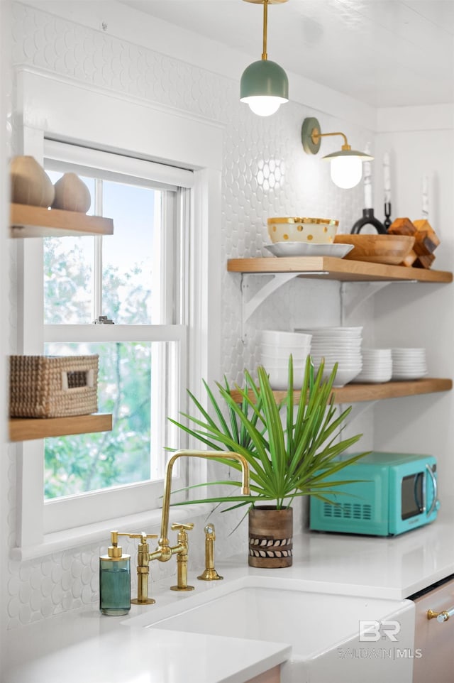 details with white microwave, a sink, and open shelves