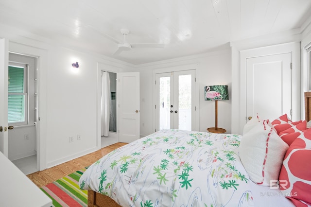 bedroom featuring ceiling fan, french doors, access to outside, and light wood-style flooring