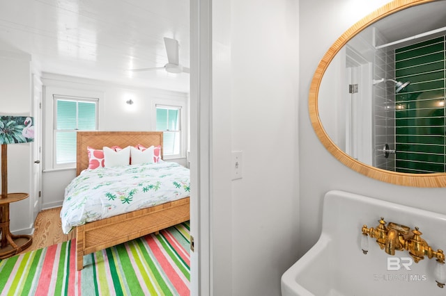 bedroom with multiple windows and wood finished floors