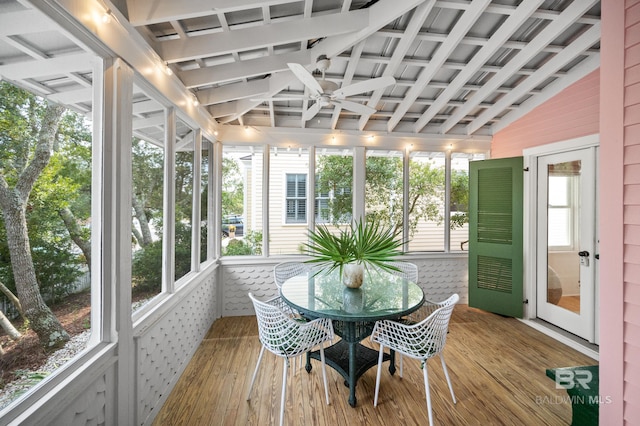 sunroom / solarium featuring a ceiling fan, vaulted ceiling, and hardwood / wood-style flooring