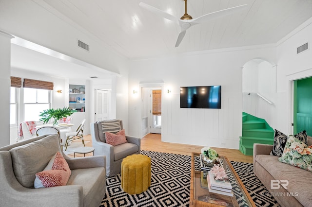 living room featuring crown molding, wood finished floors, and visible vents