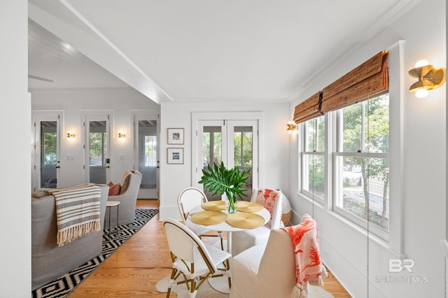 dining room with crown molding and wood finished floors