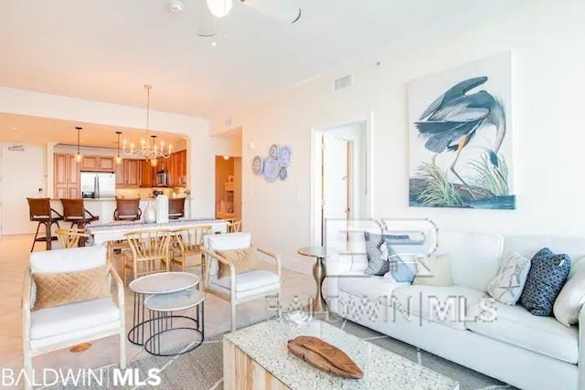 living room featuring ceiling fan with notable chandelier