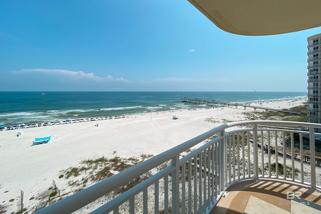 balcony with a water view and a beach view