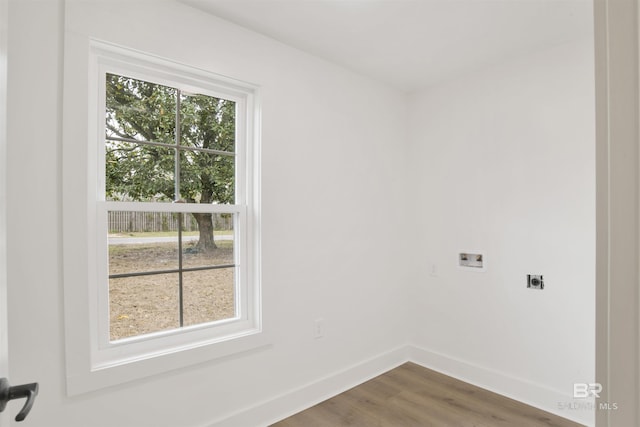 laundry room featuring washer hookup, electric dryer hookup, wood finished floors, laundry area, and baseboards