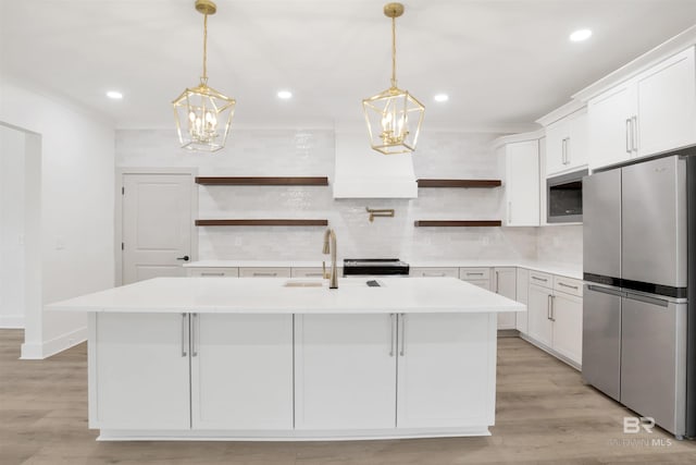 kitchen featuring appliances with stainless steel finishes, light countertops, light wood-style floors, open shelves, and backsplash