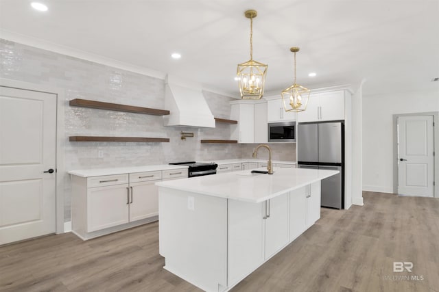 kitchen featuring custom exhaust hood, open shelves, freestanding refrigerator, a sink, and built in microwave