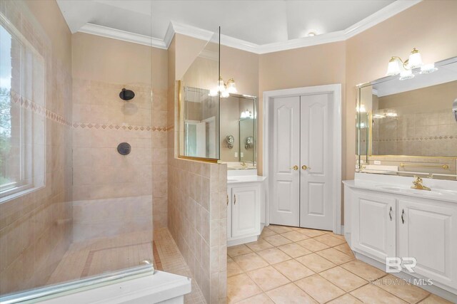 bathroom featuring tiled shower, vanity, and crown molding