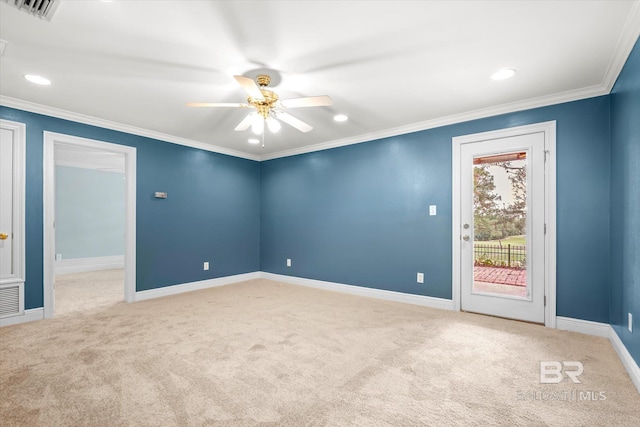 carpeted spare room featuring ceiling fan and ornamental molding