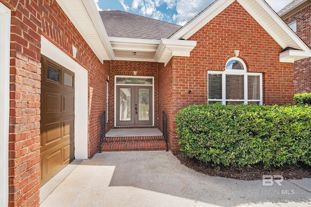 property entrance with a garage and french doors