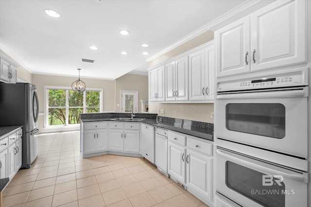 kitchen with ornamental molding, white appliances, sink, and white cabinets