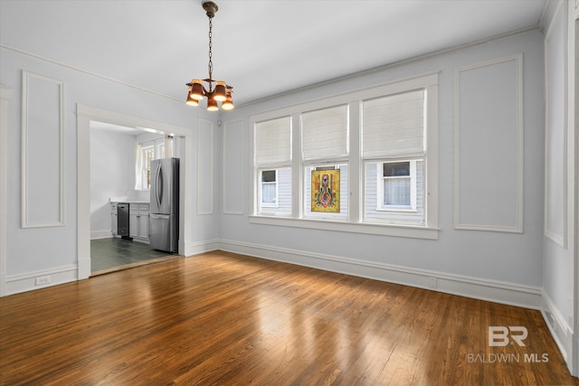 24 Macy Pl, Mobile, AL 36604 - empty room with a chandelier, dark wood-style floors, and baseboards