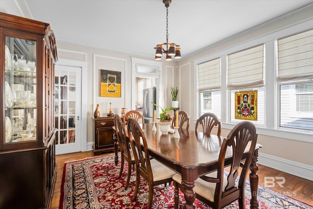 24 Macy Pl, Mobile, AL 36604 - dining room with a chandelier, wood finished floors, ornamental molding, and baseboards