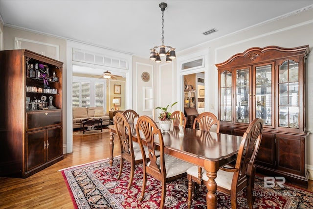 24 Macy Pl, Mobile, AL 36604 - dining room with a chandelier, light wood-style floors, and crown molding