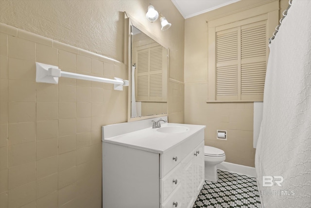 24 Macy Pl, Mobile, AL 36604 - full bathroom featuring toilet, vanity, tile walls, ornamental molding, and tile patterned floors