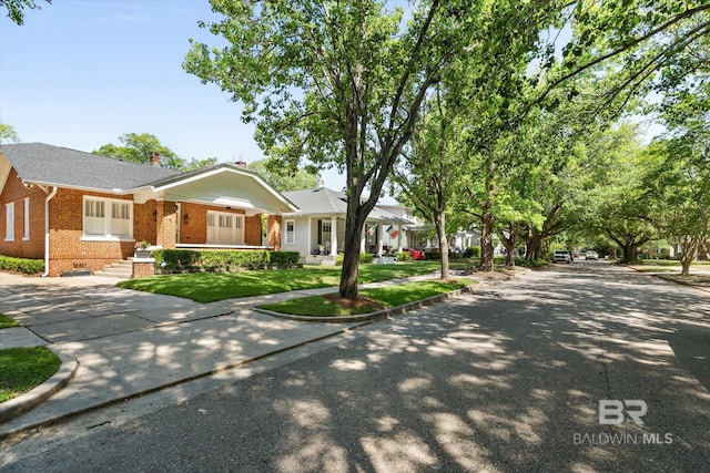 24 Macy Pl, Mobile, AL 36604 - ranch-style house with brick siding, a chimney, and a front yard