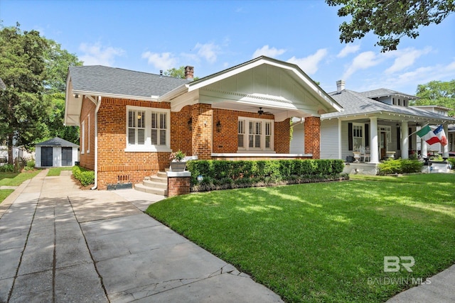 24 Macy Pl, Mobile, AL 36604 - view of front of property featuring brick siding, a front yard, a ceiling fan, and a garage