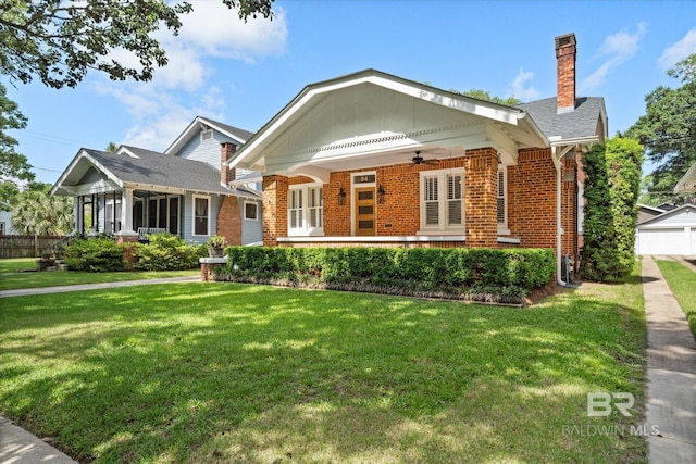 24 Macy Pl, Mobile, AL 36604 - view of front of property with brick siding, a ceiling fan, and a front yard