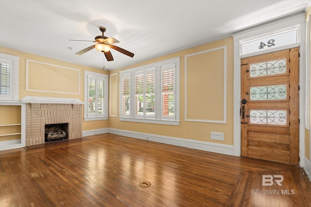 24 Macy Pl, Mobile, AL 36604 - unfurnished living room with a ceiling fan, wood finished floors, a brick fireplace, baseboards, and crown molding