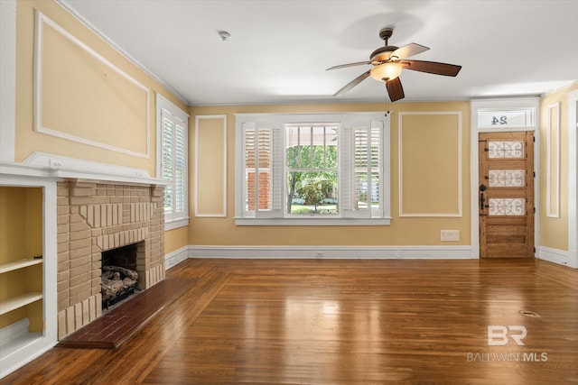 24 Macy Pl, Mobile, AL 36604 - unfurnished living room featuring a ceiling fan, a fireplace, wood finished floors, and baseboards