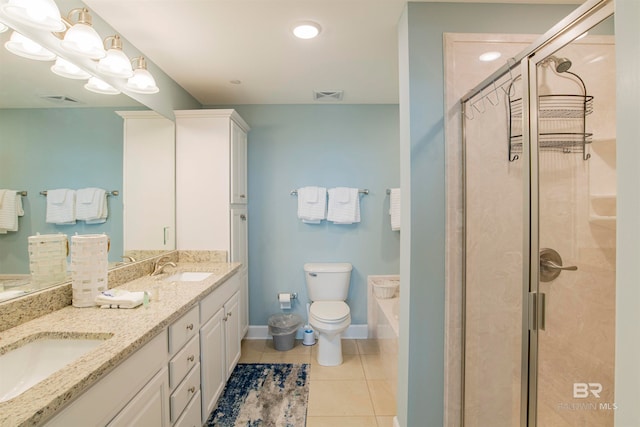 bathroom with tile patterned flooring, vanity, a shower with door, and toilet