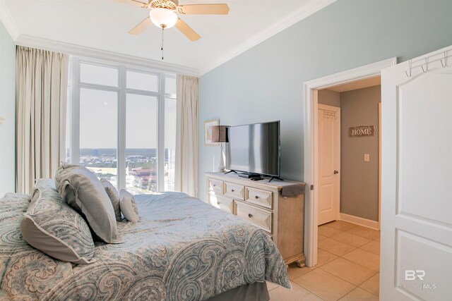 bedroom with crown molding, light tile patterned floors, and ceiling fan