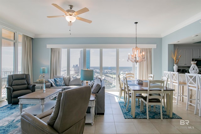 dining area with ceiling fan with notable chandelier, plenty of natural light, light tile patterned floors, and crown molding