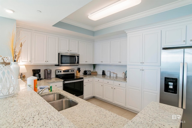 kitchen with light stone countertops, stainless steel appliances, white cabinets, sink, and crown molding