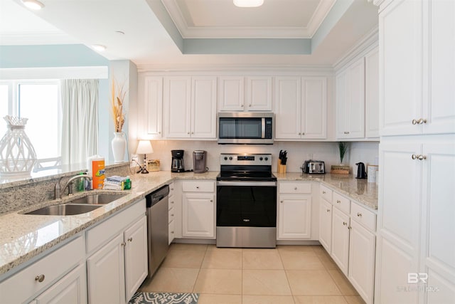 kitchen with sink, stainless steel appliances, light stone countertops, white cabinets, and light tile patterned floors