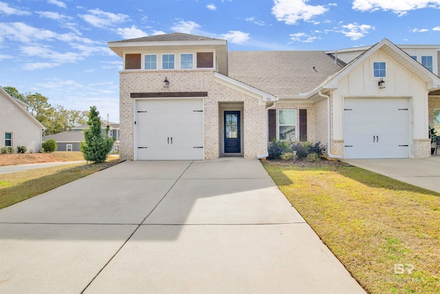 view of front of property featuring a front lawn and a garage