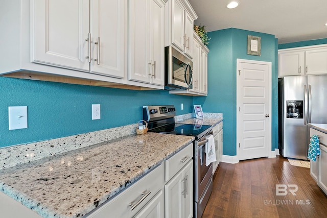 kitchen featuring white cabinetry, light stone counters, and stainless steel appliances