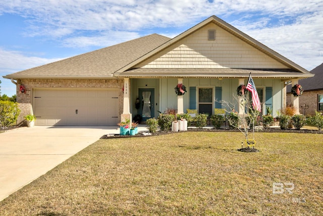 view of front of home with a garage, covered porch, and a front lawn