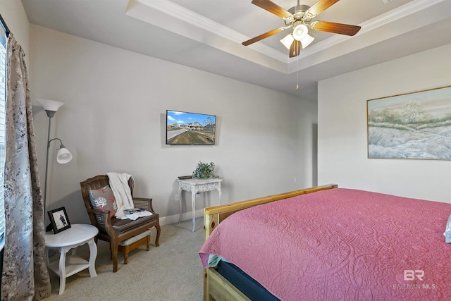 bedroom featuring a raised ceiling, crown molding, light carpet, and ceiling fan